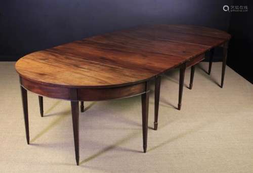 A George III Mahogany Dining Table composed of three separate parts;