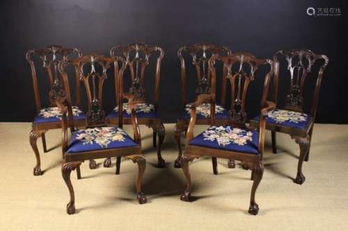 A Set of Six Carved Mahogany Chippendale Style Dining Chairs, including two Armchairs.