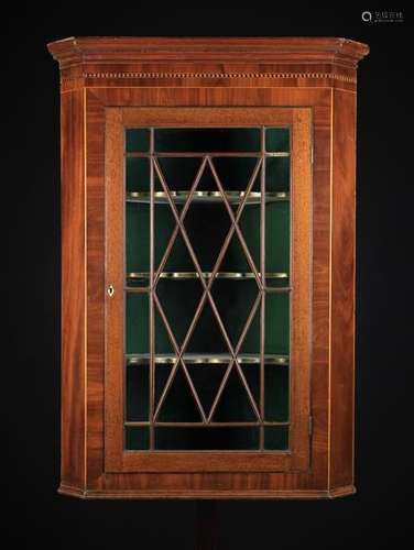 A Large Late Georgian Mahogany Corner Cupboard inlaid with decorative chequer bands and stringing.