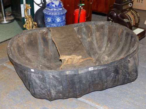 A HAND MADE VINTAGE CORACLE OF TRADITIONAL CONSTRUCTION AND COMPLETE WITH PADDLE. 124 x 95cms.
