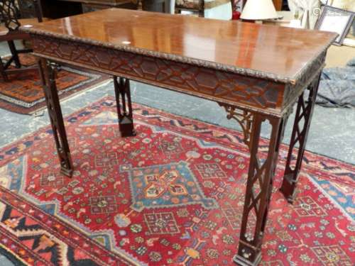 AN ANTIQUE CHIPPENDALE DESIGN MAHOGANY CENTRE TABLE WITH RIBBON CARVED EDGE TOP OVER BLIND FRET
