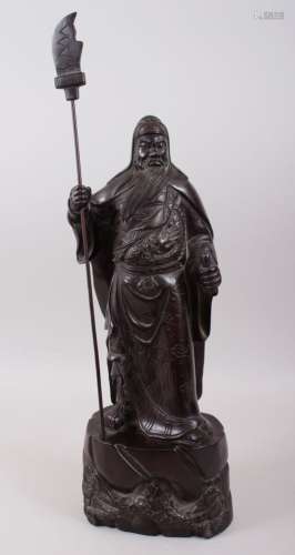A GOOD 19TH / 20TH CENTURY CHINESE HARDWOOD HARVED FIGURE OF A BEARDED WARRIOR, stood on a tree
