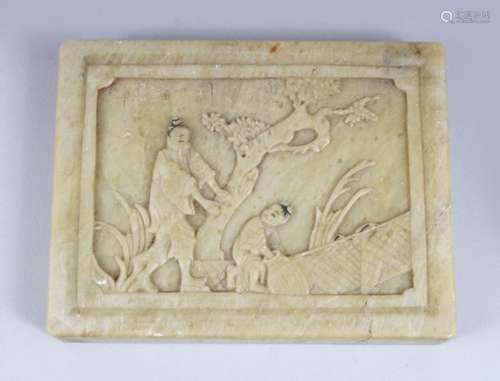 A 20TH CENTURY CHINESE CARVED JADE / SOAPSTONE PLAQUE, depicting two figures in an exterior setting,