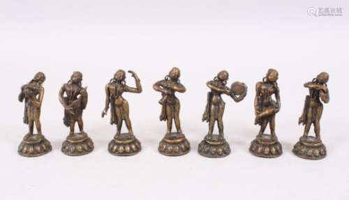 A MIXED LOT OF SEVEN 19TH / 20TH CENTURY INDIAN BRONZE MUSICIAN FIGURES, each holding a different