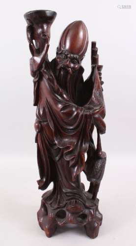 A GOOD LARGE 19TH CENTURY CHINESE CARVED HARDWOOD FIGURE OF SHOU LOU, he is stood holding his scroll