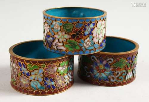 THREE JAPANESE MEIJI PERIOD CLOISONNE ENAMEL SERVIETTE RINGS, 5.3cm.