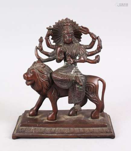 A GOOD INDIAN BRONZE FIGURE OF A BUDDHA / GODDESS - DURGA ON LION, seated upon the back of a lion,