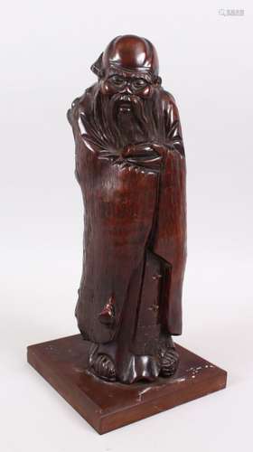 A GOOD 19TH CENTURY NATURALISTIC HARDWOOD CARVED FIGURE OF SHOU LOU, stood enclosed in his robes,