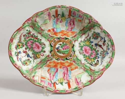 A CANTON OVAL DISH with four panels of birds, butterflies and flowers. 10ins wide.