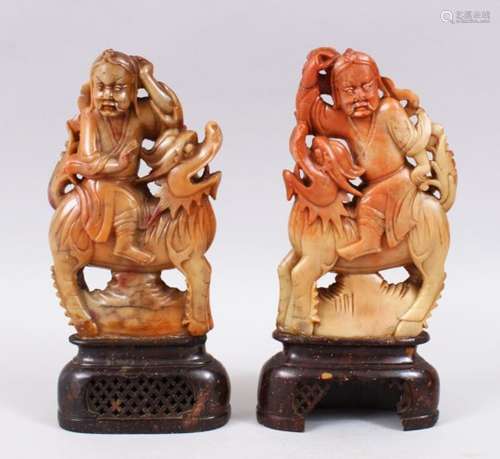 PAIR OF 20TH CENTURY CHINESE CARVED SOAPSTONE FIGURES OF IMMORTALS, the immortals riding upon the