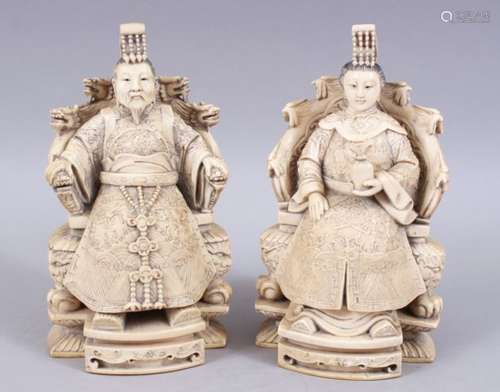 A PAIR OF LATE 19TH CENTURY CHINESE CARVED IVORY SEATED EMPEROR QIANLONG AND EMPRESS,heavily