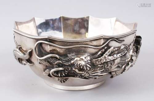 A LARGE JAPANESE MEIJI PERIOD SOLID SILVER DRAGON BOWL, the bowl decorated in relief to depict a