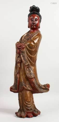 A SUPERB 18TH CENTURY CHINESE CARVED WOOD FIGURE OF GUANYIN standing with arms crossed. 23ins high.