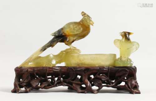 A GOOD 19TH CENTURY CHINESE CARVED JADE GROUP OF TWO BIRDS on a pierced wooden stand. 6ins long.