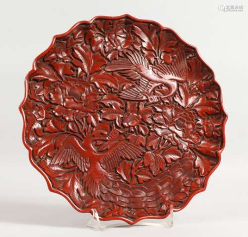 A GOOD CHINESE CINNABAR LACQUER CARVED CIRCULAR DISH with birds and flowers. 10ins diameter.