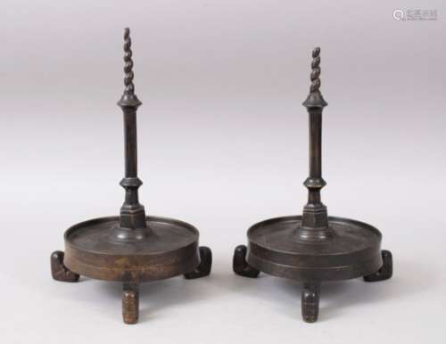 A PAIR OF EARLY POSS 16TH / 17TH CENTURY CHINESE / TIBETAN BRONZE CANDLESTICKS, the cylindrical drip