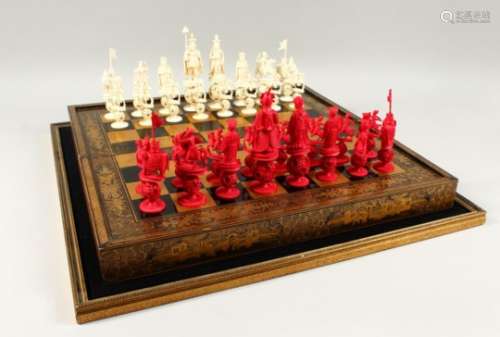 A GOOD 19TH CENTURY CHINESE CARVED & STAINED IVORY CHESS SET WITH GOLD LACQUER FOLDING GAMES BOARD /