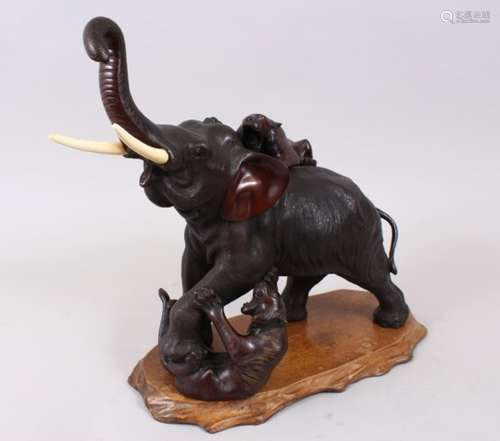 A GOOD JAPANESE MEIJI PERIOD BRONZE ELEPHANT & TIGER GROUP OKIMONO, the elephant in a striding pose