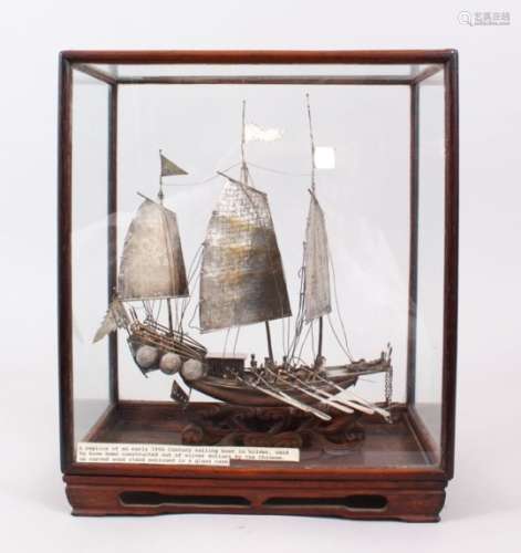A GOOD 19TH CENTURY CHINESE SOLID SILVER MODEL OF A JUNK BOAT, the ship housed upon a carved wave
