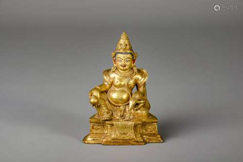A Sino-Tibetan gilt bronze figure of Jambhala,