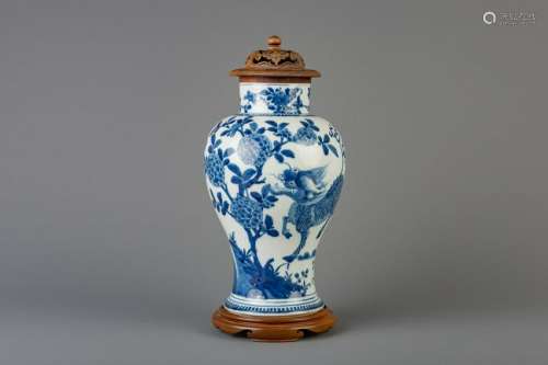 A Chinese blue and white 'kylin' vase with wooden cover