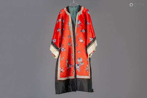 A Chinese red ground embroidered silk robe, 19th C.