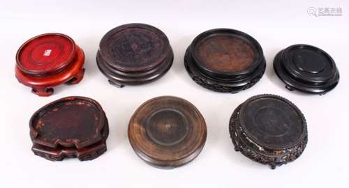 A MIXED LOT OF SEVEN CHINESE HARDWOOD STANDS, to fit vases with a diameter 5.5