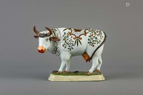 A Dutch Delft polychrome cow on base, 18th C.