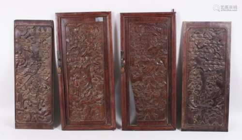 FOUR CHINESE 19TH CENTURY CARVED HARDWOOD PANELS / DOORS, the carved panels / doors once forming