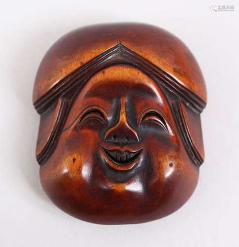 A GOOD JAPANESE MEIJI PERIOD CARVED WOODEN NETSUKE MASK OF OKAME, bearing a humorous face, himotoshi