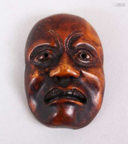 A GOOD JAPANESE MEIJI PERIOD CARVED WOODEN NETSUKE MASK OF A DOLEFUL MAN, himotoshi formed naturally