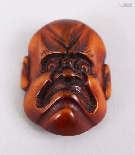 A SMALLER JAPANESE MEIJI PERIOD CARVED WOODEN NETSUKE MASK OF A DOLEFUL MAN, himotoshi formed