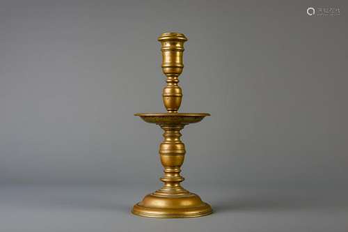 A large bronze disc candlestick or a so-called