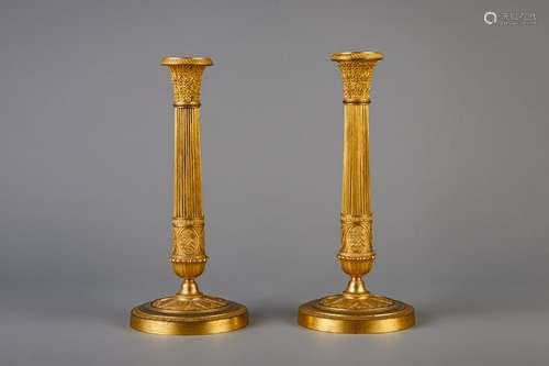 A pair of Neoclassical gilt bronze candlesticks,