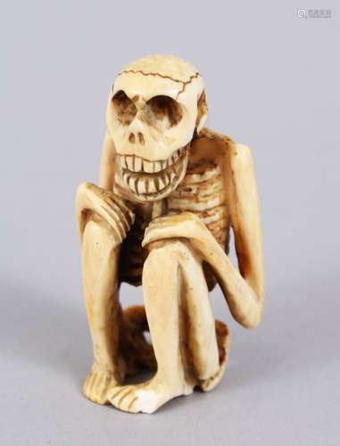 A GOOD JAPANESE MEIJI PERIOD CARVED IVORY NETSUKE OF A SKELETON, in a crouched position, himotoshi