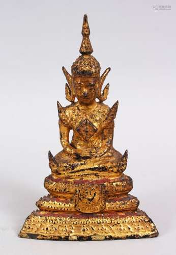 A SMALL TIBETAN GILT BRONZE FIGURE OF A BUDDHA / DEITY, in a seated position in meditation, the