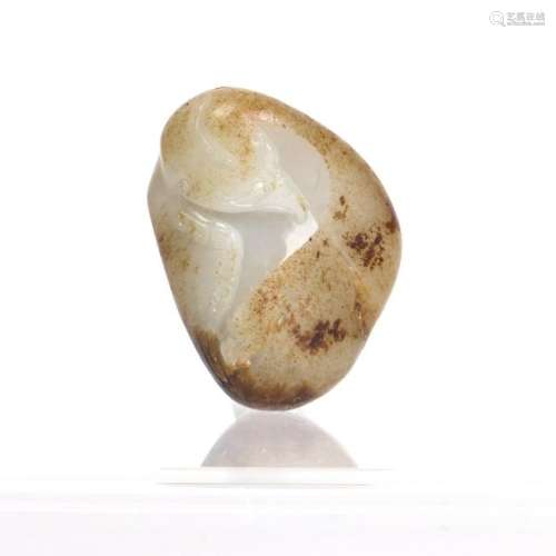 A WHITE AND RUSSET JADE CARVED OF EAGLE