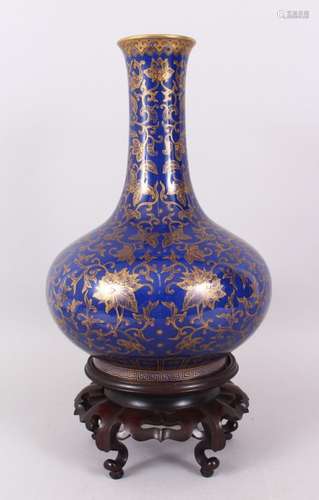 A FINE POWDER BLUE BOTTLE VASE, Imperial quality, the body strewn with gilt leaves and scrolls on