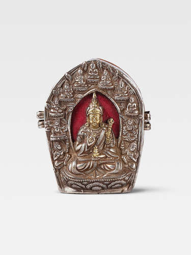 A PARCEL GILT SILVER REPOUSSÉ GAU OF PADMASAMBHAVA  BHUTAN, CIRCA 19TH CENTURY