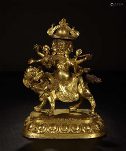 TIBETAN GILT BRONZE BUDDHIST GUARDIAN ON BEAST