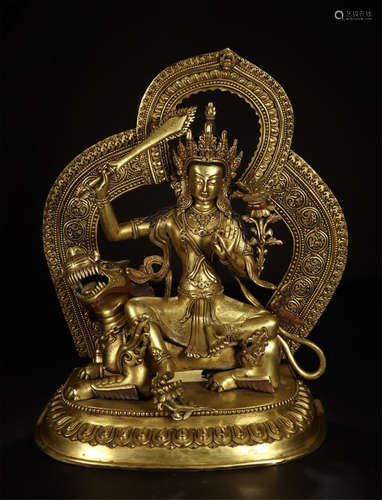 CHINESE GILT BRONZE SEATED BUDDHIST GUARDIAN ON BEAST