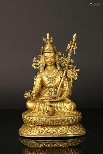 TIBETAN GILT BRONZE SEATED BUDDHIST GUARDIAN