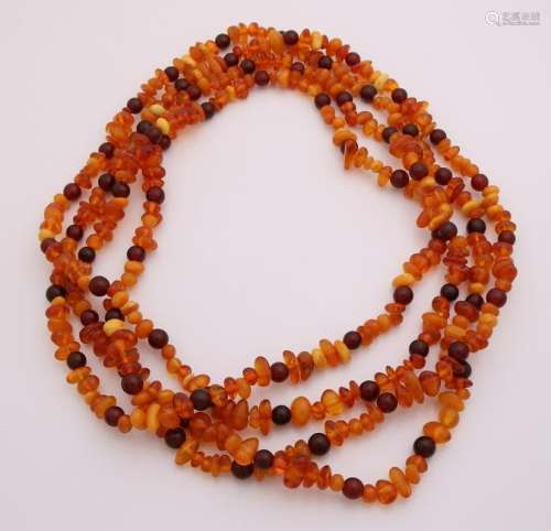 Long amber necklace with various shaped beads. length