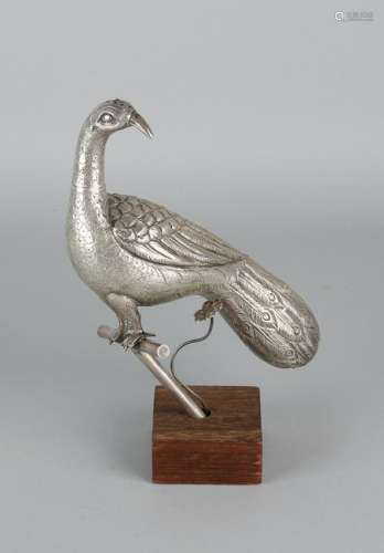 Silver peacock, BWG, mounted on a stick on a wooden