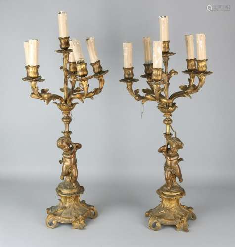 Two gilt bronze candlesticks with putti. Circa 1900.