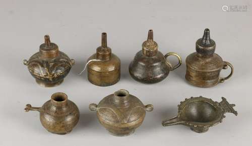 Seven antique Eastern bronze oil lamps. Divers.