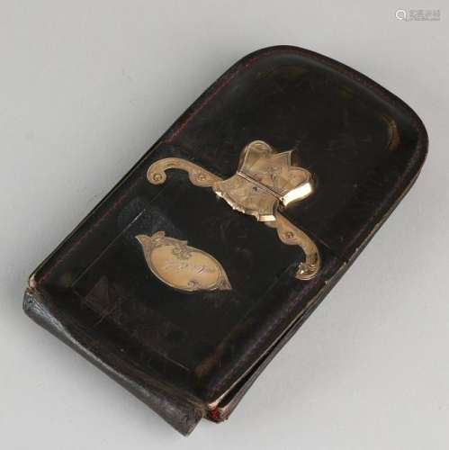 Leather cigar case with golden clasp and element,