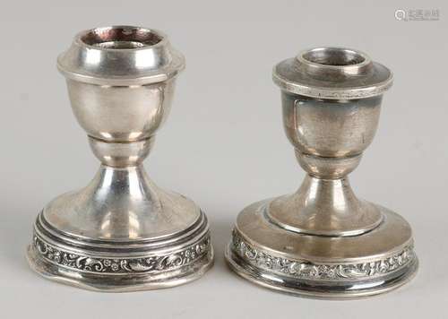 Two silver candlesticks, 835/000, low table