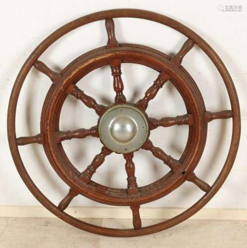Large antique mahogany ship steering wheel. First half