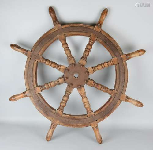 Antique ship steering wheel. Mahogany with iron bands.